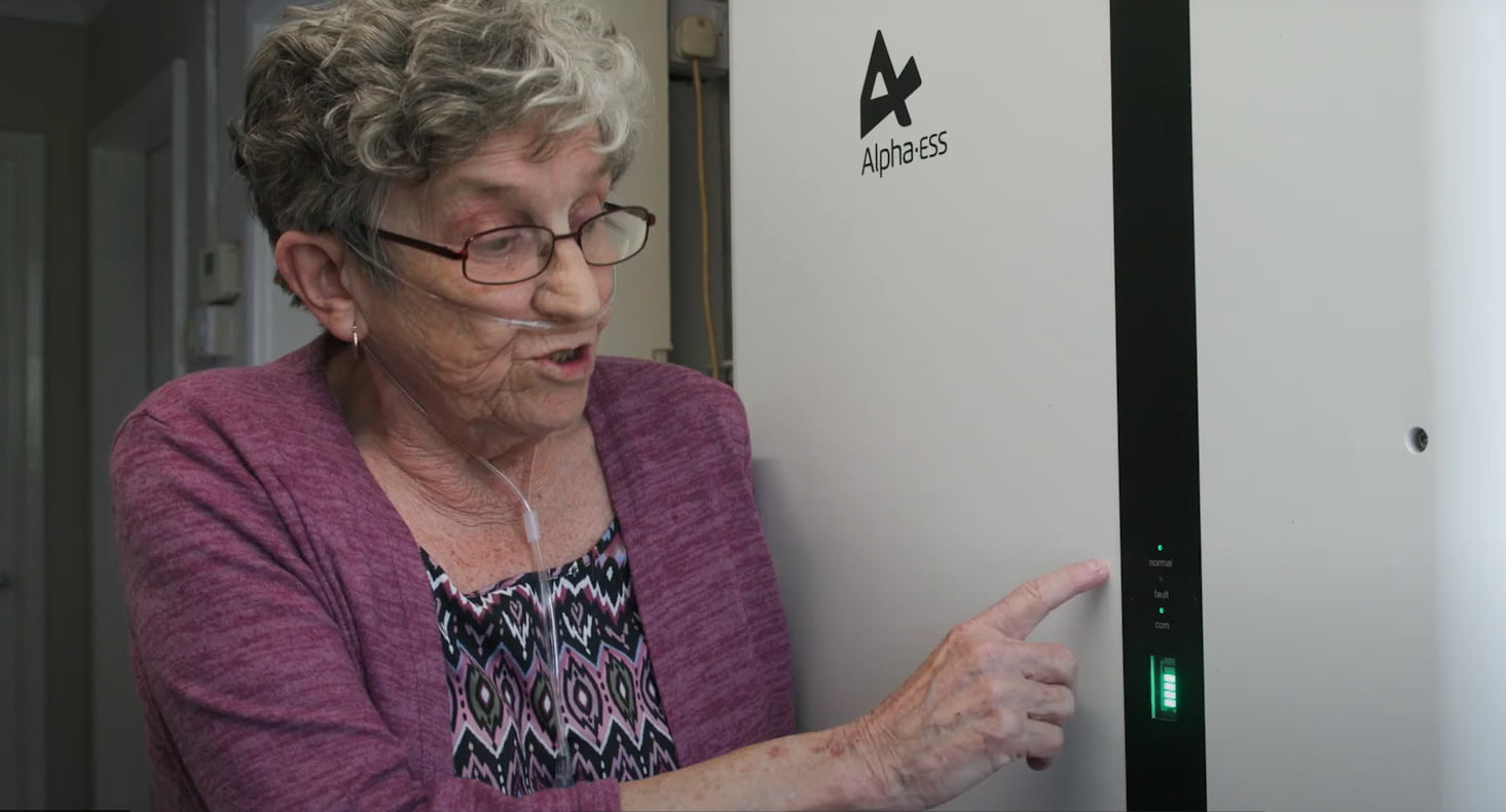 Elderly resident looknig at her solar battery